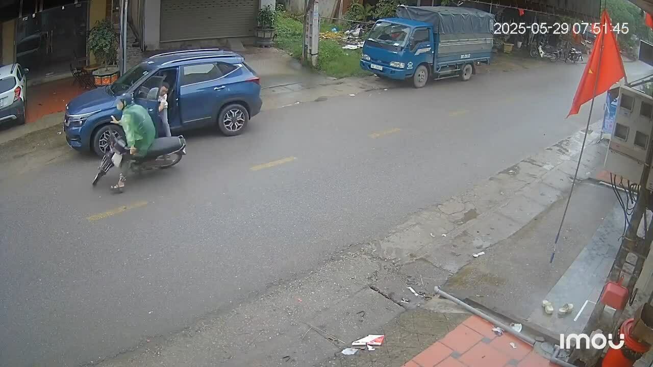 Tài xế mở cửa ôtô đẩy xe máy bay ra giữa đường
